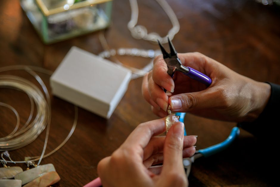 Detailed view showcasing the art of jewelry making with pliers and delicate hands.
